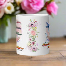 Load image into Gallery viewer, Back side view white glossy mug displaying a pastel floral arrangement with pink butterflies, purple sparkles, and a soft, light-colored background.
