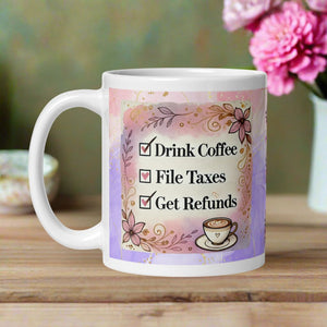 Left side view of a white glossy mug with a to-do list checklist that reads, “Drink coffee, file taxes, get refund,” surrounded by a pastel floral frame, a small cup of coffee in the corner, and a pastel watercolor pink and purple background with a golden stream of glitter.