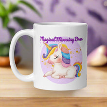 Load image into Gallery viewer, Left side view of a white glossy mug featuring the phrase &quot;Magical Morning Brew&quot; and a colorful-maned white unicorn with a golden horn, surrounded by golden sparkles and set against a purple circular background.
