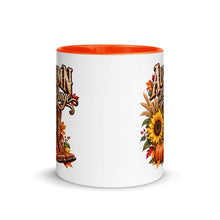 Load image into Gallery viewer, A white ceramic coffee mug with a bright orange handle and interior, featuring a western-themed autumn graphic with the text 'Autumn on the Range' above cowboy boots, pumpkins, sunflowers, and fall leaves.
