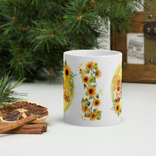 Load image into Gallery viewer, Back side view of a white glossy mug showcasing a stalk of sunflowers, small playful gnomes decorated with sunflower accents, a small pumpkin, and golden sparkles.
