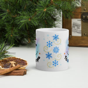 Back side view of a white glossy mug with blue snowflakes, golden swirls, small blue snowflakes, and golden speckles in the background.