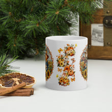 Load image into Gallery viewer, Back side view of a white glossy mug with a fall flower arrangement design surrounding pumpkins and small butterflies.
