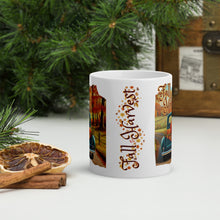 Load image into Gallery viewer, Back side view of a white glossy mug showcasing the phrase &quot;Fall Harvest&quot; with a design of autumn leaves, small acorns, pine cones, and a playful squirrel.
