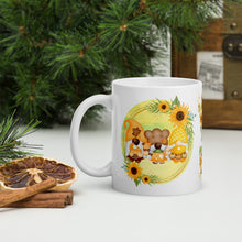 Load image into Gallery viewer, Left side view of a white glossy mug featuring a design of festive fall gnomes holding Thanksgiving desserts, encircled by a sunflower wreath on a yellowish-green background.
