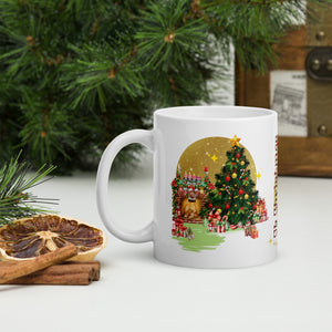 Left side view of a white glossy mug featuring a decorative Christmas tree surrounded by golden sparkles, colorful presents, gingerbread man and woman, a festive fireplace with candles on the mantle, and a red lantern, with a golden sparkle circle around the tree.