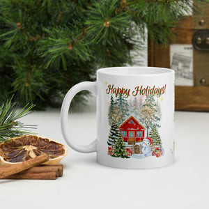 Left side view of white glossy mug with the phrase "Happy Holidays" in festive font, showcasing a wintery scene with a red house, snow-covered trees, a dancing snowman, and a decorated Christmas tree surrounded by gifts and golden sparkles.