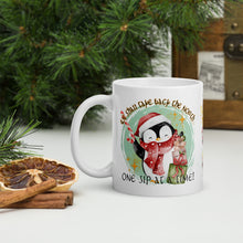 Load image into Gallery viewer, Left side view of a white glossy mug with an image of a cute penguin holding a candy cane, standing next to presents, with a light green-hued circle in the background and the phrase &quot;We shall take back the North one sip at a time.&quot;
