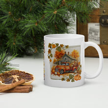 Load image into Gallery viewer, Right side view of a white glossy mug featuring an old orange truck with a bed full of pumpkins and harvest goods, set against a gray farmhouse in the background, with orange hues and an autumn frame surrounding the image.
