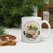 Load image into Gallery viewer, Right side view of white glossy mug with the phrase &quot;We Wish You A Merry Christmas and a Happy New Year,&quot; featuring a festive mug surrounded by gingerbread cookies, holly, pine tree clippings, and a candy cane, with golden sparkles and a yellow circle background.
