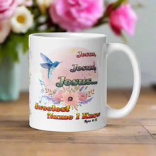 Load image into Gallery viewer, Right side view white glossy mug featuring the phrase &quot;Jesus, Jesus, Jesus, Sweetest Name I Know&quot; with a pastel floral arrangement, a blue mockingbird, swaying musical notes, and a light pink hue circle background with a Bible verse.
