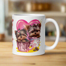 Load image into Gallery viewer, Right side view white glossy mug featuring cute watercolor puppies sitting in a mug of chocolate with golden sparkles behind them, a pink heart in the background, yellow hues, and candy and chocolates scattered around.
