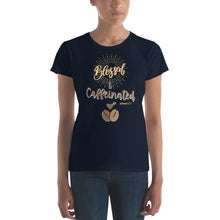 Load image into Gallery viewer, Woman modeling womens fitted navy t-shirt with image phrase blessed and caffeinated, with image graphic of words in coffee oriented hues, coffee beans, brown small hearts
